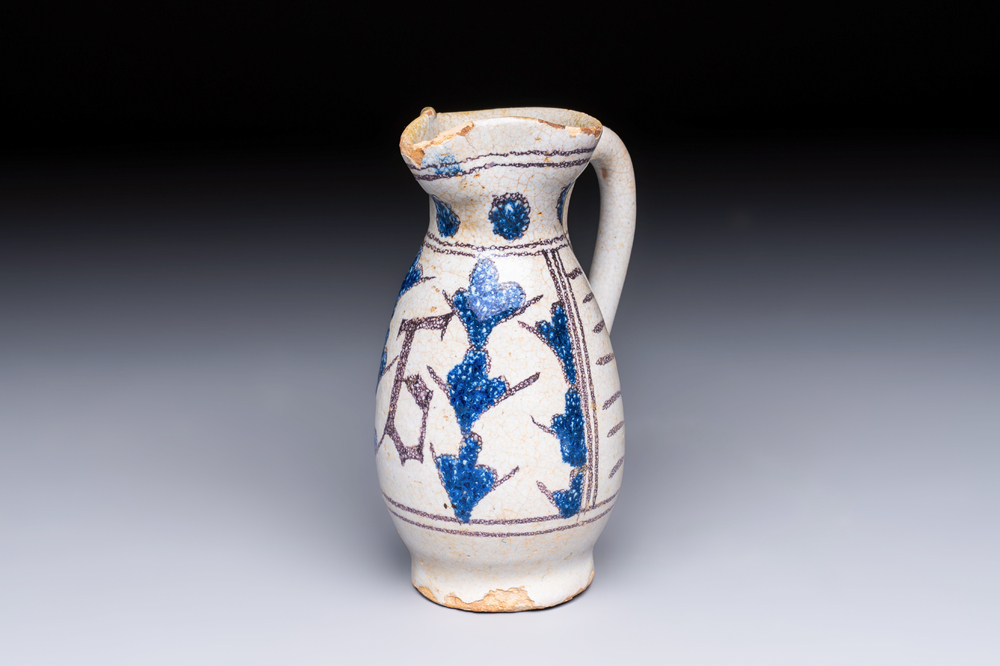 A rare intact early Italian maiolica ewer inscribed 'G', Montelupo, 15th C.