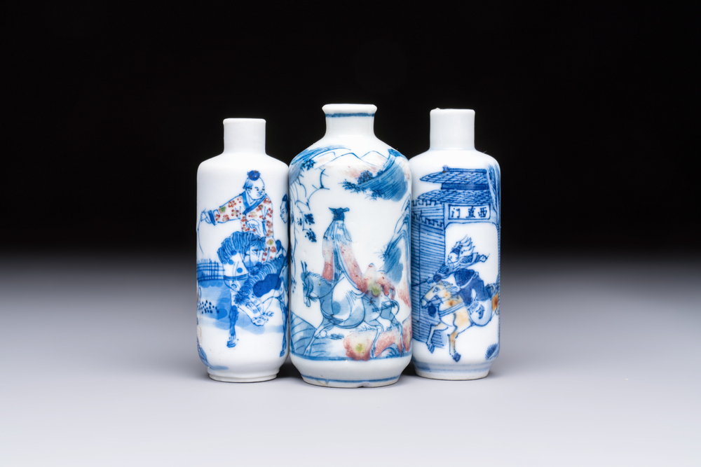 Three Chinese blue, white and copper-red snuff bottles with narrative design, 19th C.