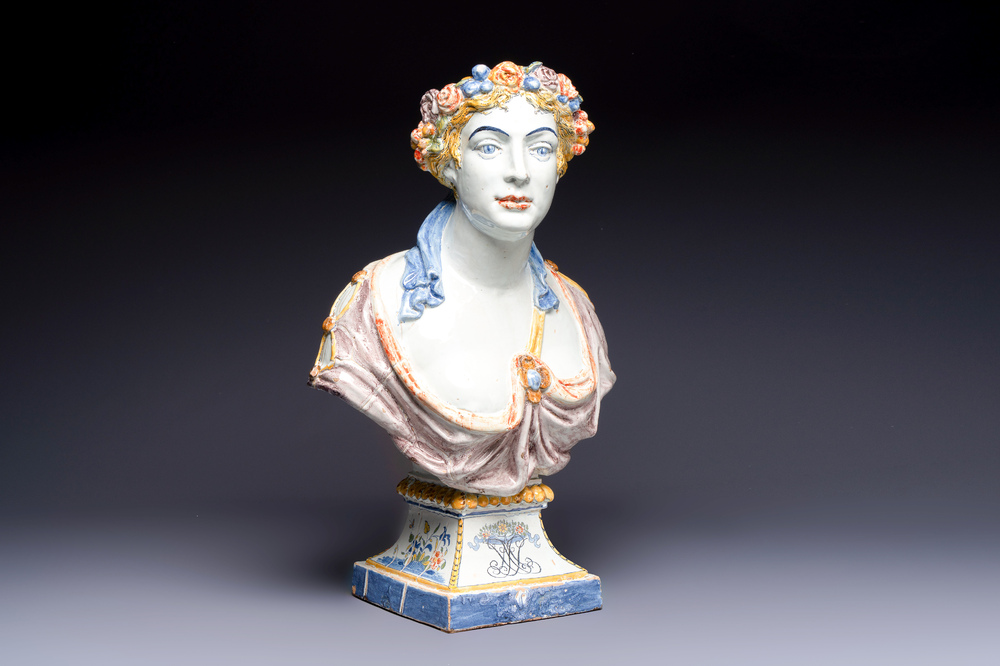A large polychrome French faience monogrammed bust of a woman emblematic of spring, probably Rouen, early 19th C.