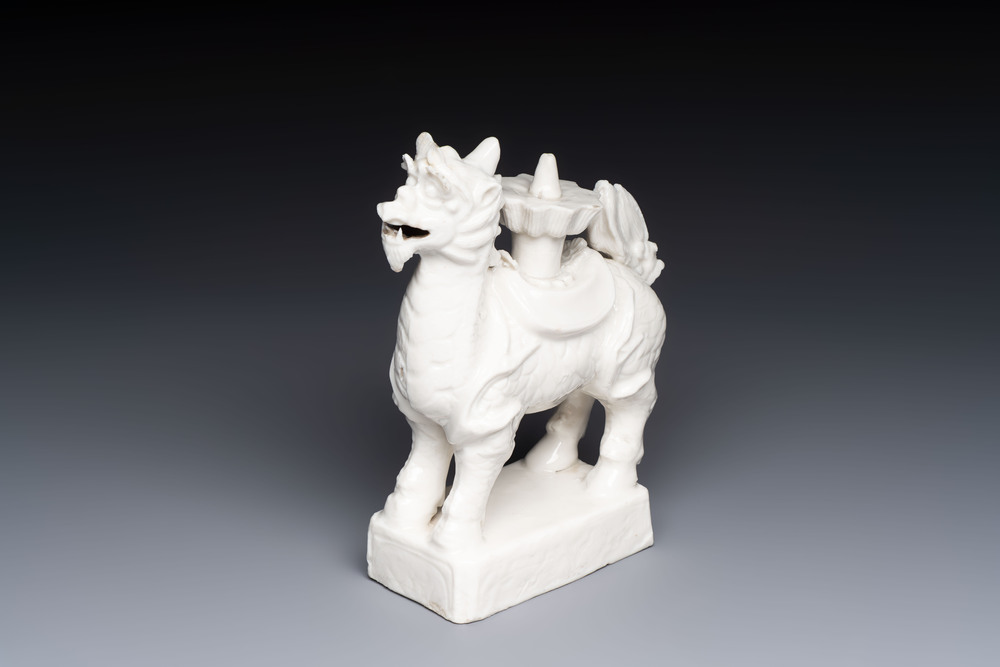 A Chinese Dehua blanc de Chine candlestick in the form a qilin, Kangxi