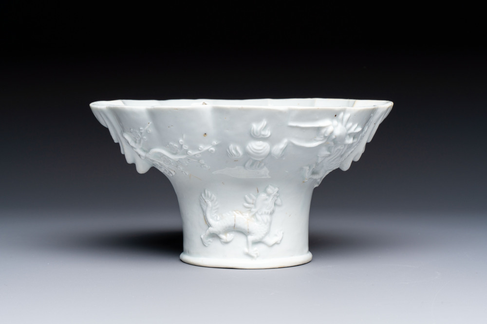 A very large Chinese Dehua blanc de Chine libation cup with a dragon, a qilin, a tiger and a crane, 18th C.