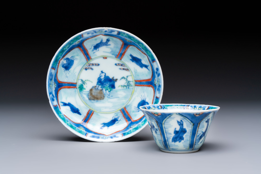 A Chinese European-decorated blue and white 'Fisherman' cup and saucer, Kangxi