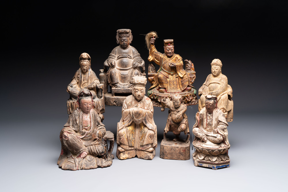 Eight Chinese carved wooden sculptures with traces of polychromy and gilding, 19th C.