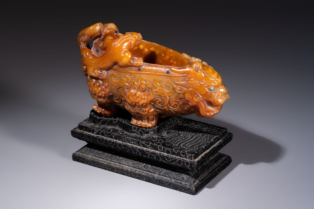 A Chinese precious-stone-inlaid carved soapstone wine vessel on stand, Gong 觥, Republic