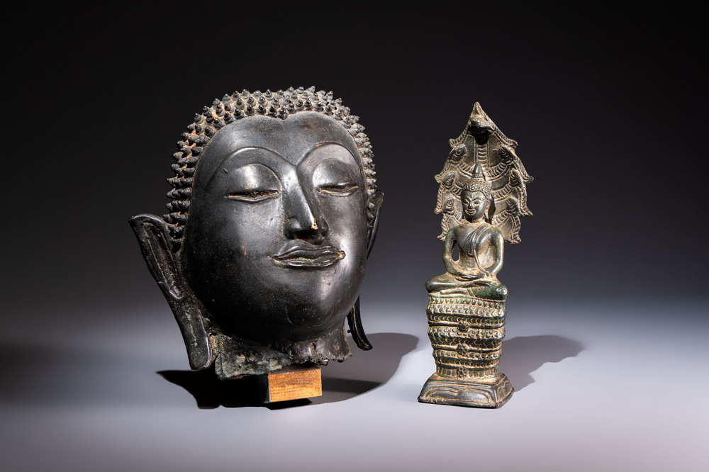 A Cambodian bronze Buddha and a Thai Buddha head, 19th C.