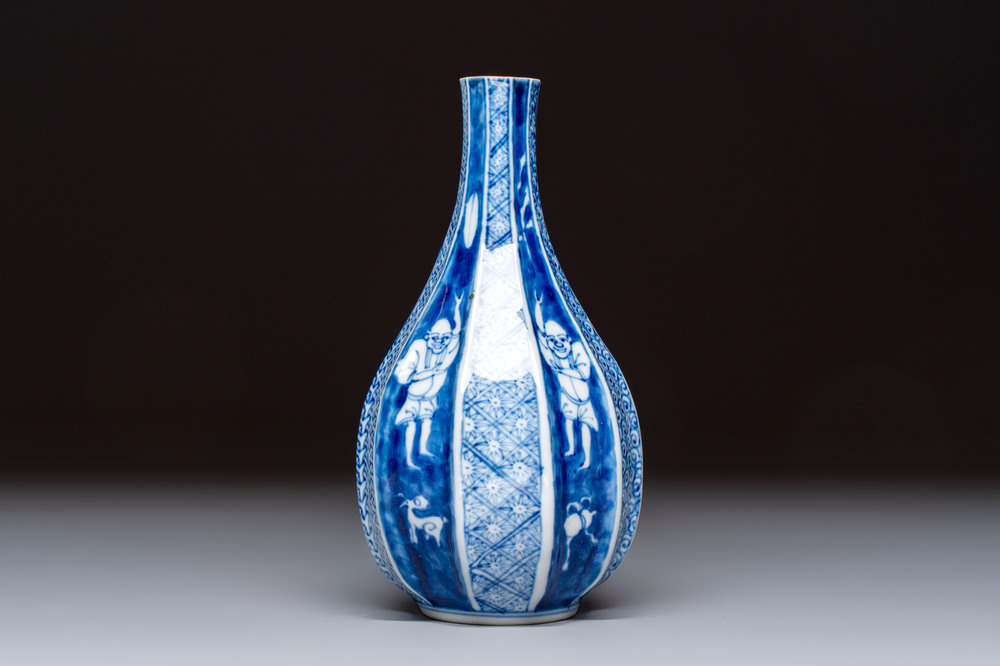 A Japanese blue and white sake bottle with figural design, Meiji, 19th C.