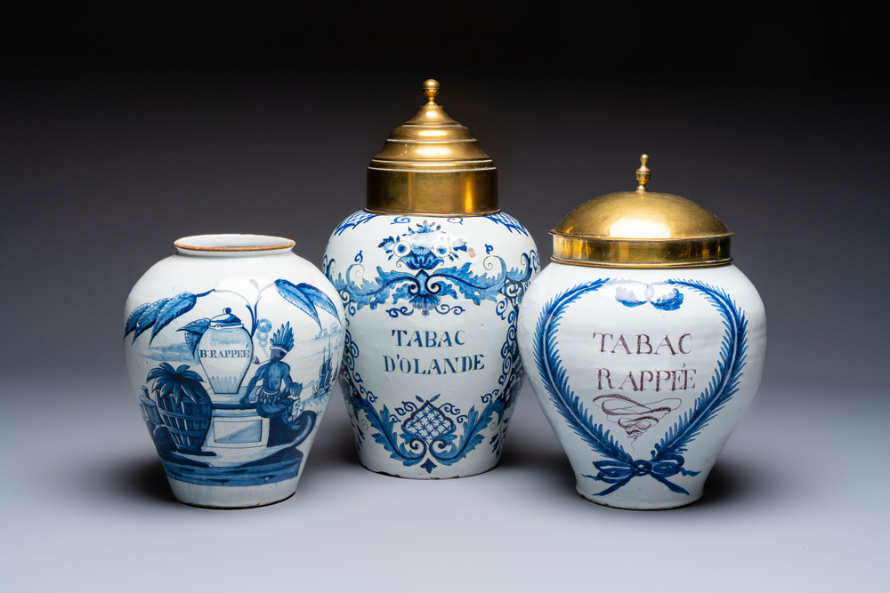 A blue and white Dutch Delft tobacco jar and two French tobacco jars with brass lids, 18/19th C.