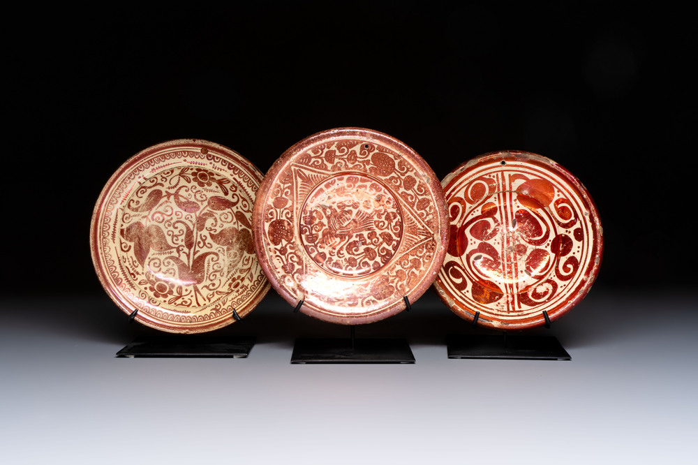 Three Hispano-Moresque lustre-ware plates on later metal stands, Spain, 17/18th C.