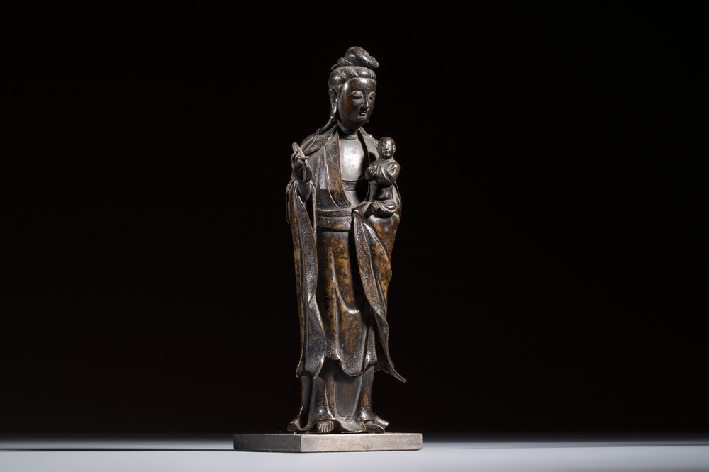 A Chinese bronze standing Guanyin with boy, Ming