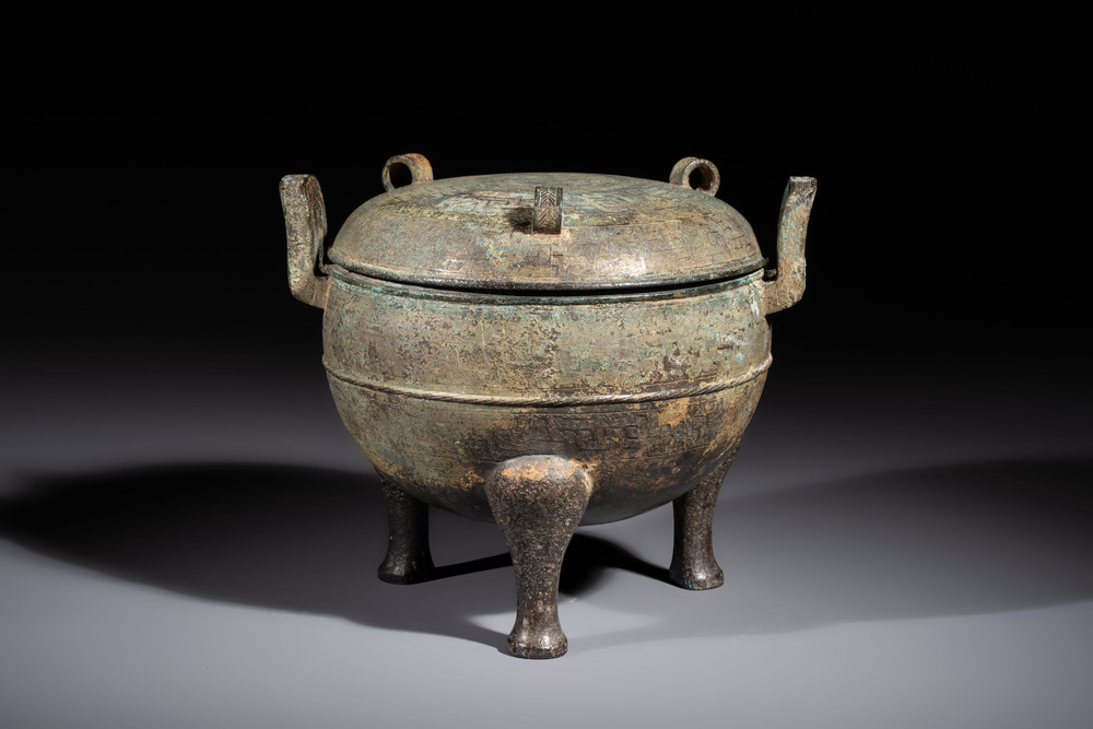 A Chinese archaic bronze tripod food vessel and cover, Ding 鼎, Eastern Zhou