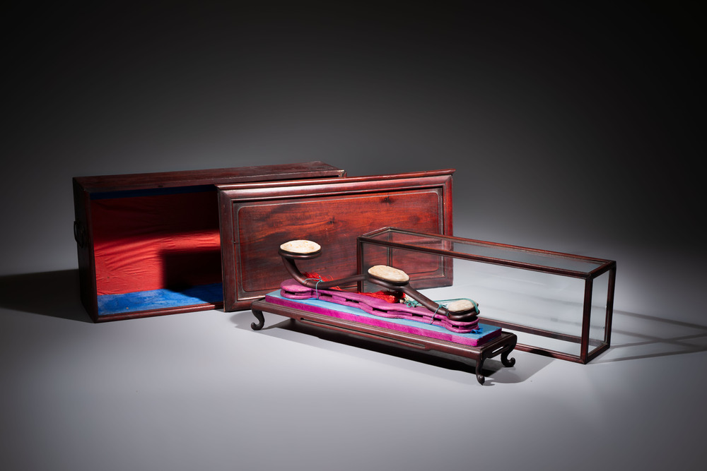 A Chinese white-jade-inset hongmu ruyi with a wooden presentation box and display case, 19th C.