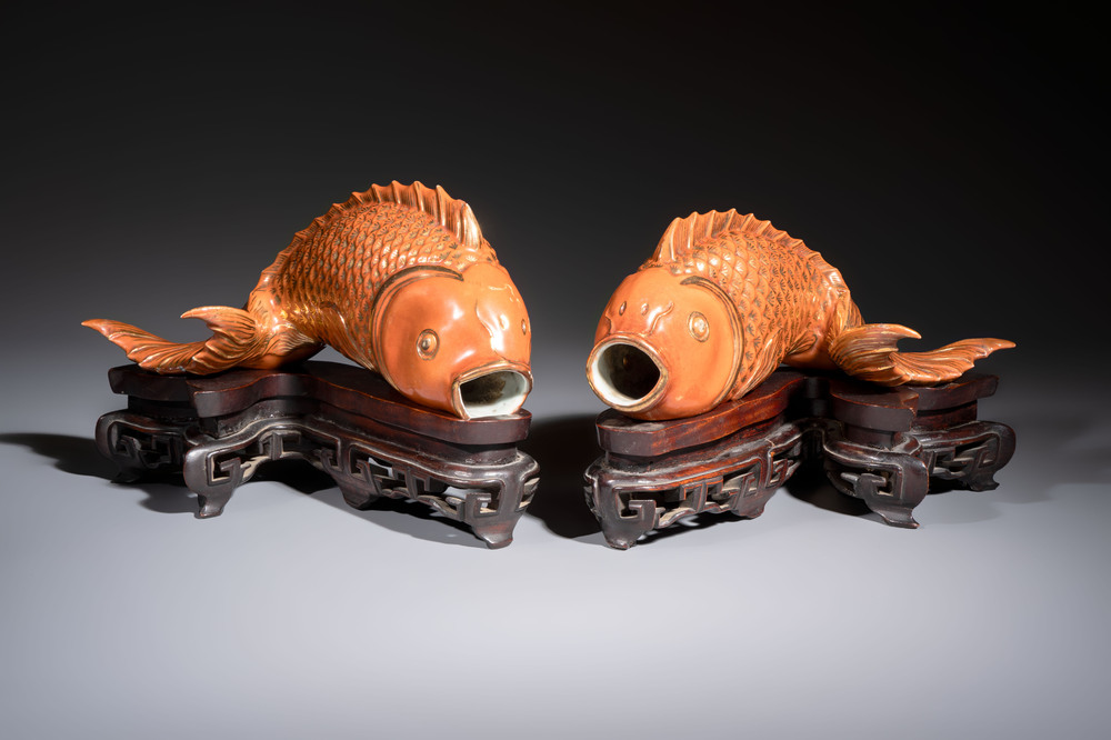A pair of Chinese coral-red-glazed gilt-decorated 'Goldfish' wall pocket vases on wooden stands, Republic