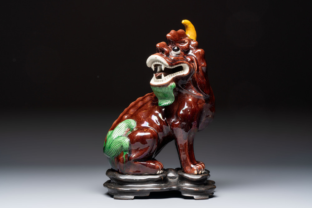 A Chinese sancai-glazed Xiezhi on a wooden stand, 19th C.