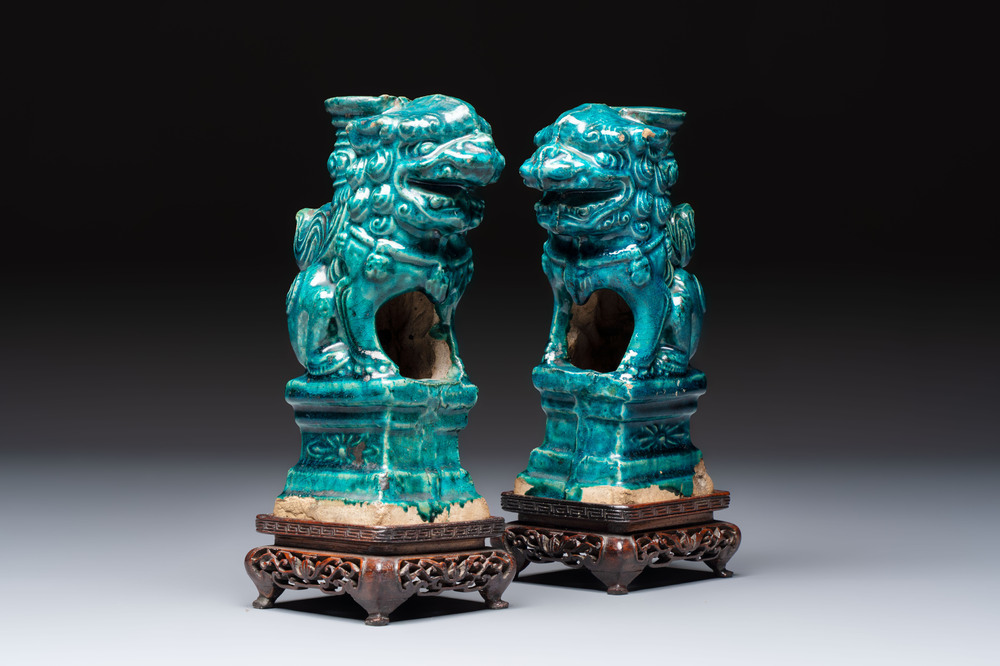 A pair of Chinese turquoise-glazed lion-shaped joss stick holders on wooden stands, Ming