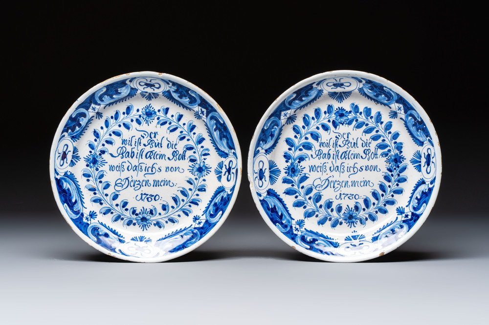 A pair of blue and white Delftware 'Proverb' plates, Germany, dated 1720
