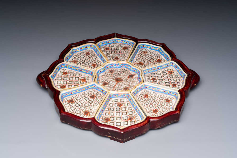 A Chinese famille rose nine-piece 'Plum Blossoms' sweetmeat set on a wooden tray, 19th C.