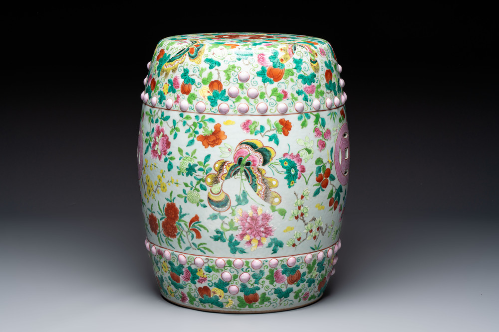 A Chinese famille rose garden seat with butterflies, flowers and fruiting branches, 19th C.