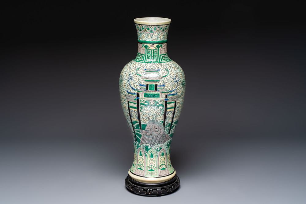 A Chinese verte biscuit 'Dragon Gate Carp 鯉躍龍門' vase on a wooden stand, Xuande mark, 19th C.