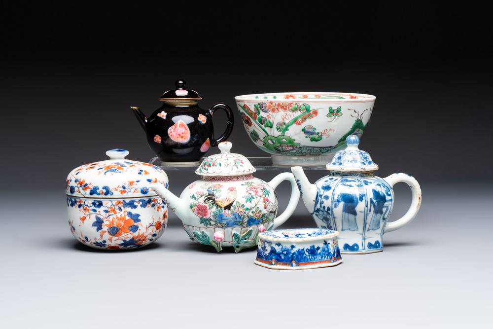 Three Chinese blue and white, famille rose and black-glazed covered teapots, a salt, an Imari-style covered bowl, and a famille verte bowl, 18th C.