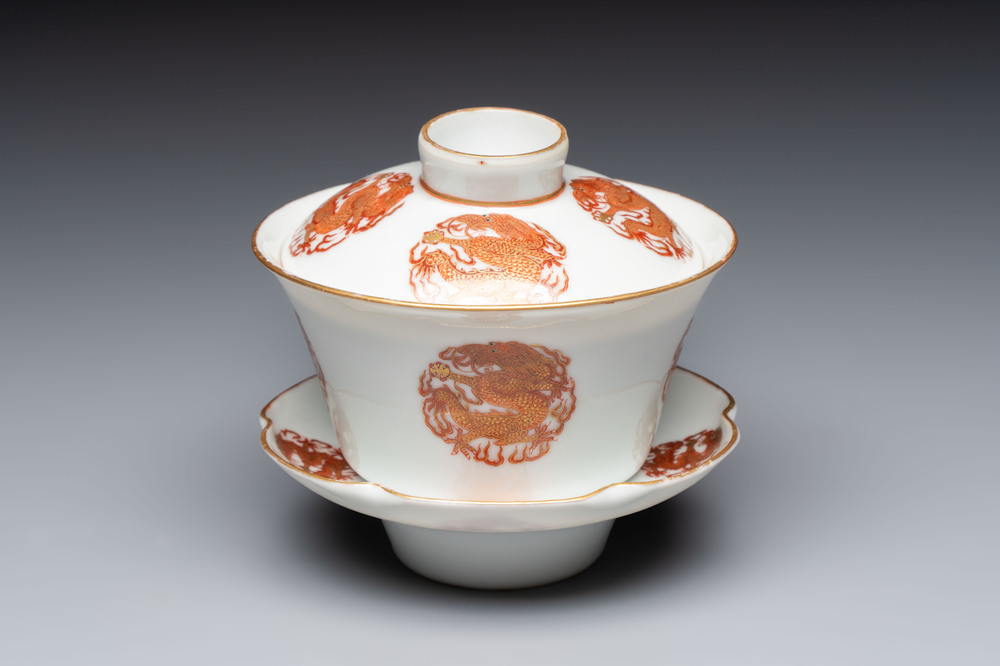 A fine Chinese iron-red gilt-decorated covered teabowl with a stand, Guangxu mark and of the period