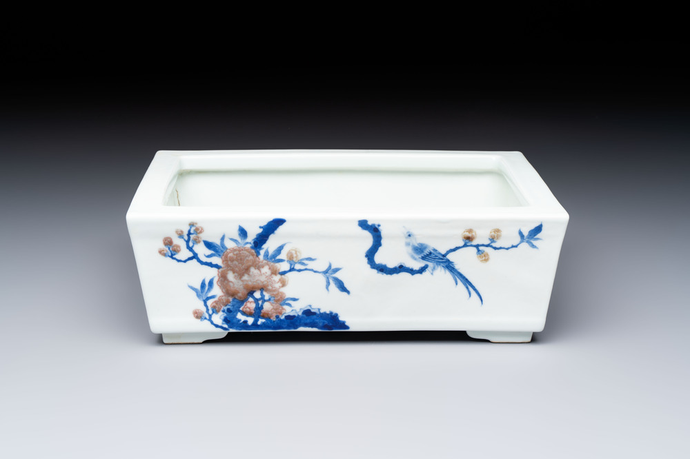 A Chinese blue, white and copper-red rectangular jardini&egrave;re with birds among flowering branches, 20th C.