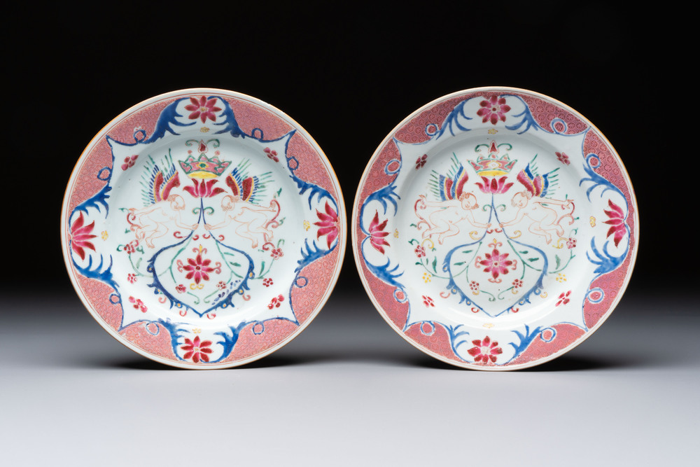 A pair of Chinese famille rose 'Winged Putti' plates, Yongzheng/Qianlong