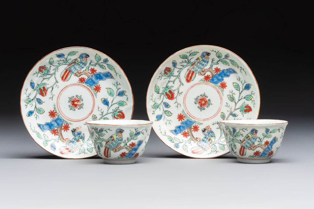Two Dutch-decorated Chinese cups and saucers with parrots among flowering branches, 18th C.