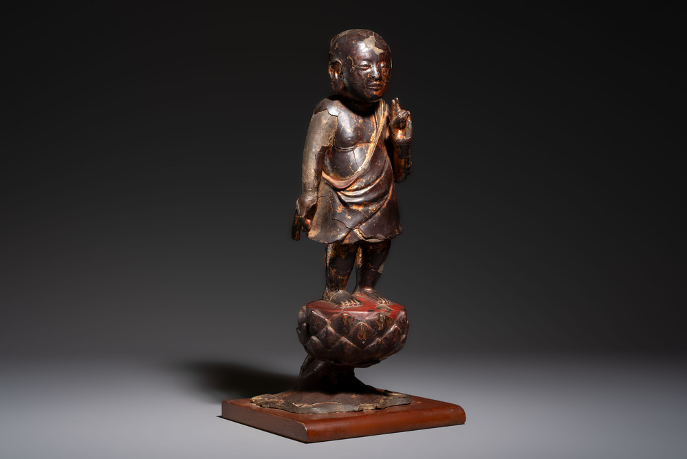 A rare Chinese gilt-lacquered bronze Buddha standing on a lotus throne, Ming
