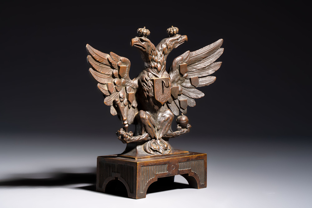 A bronze imperial Russian double-headed eagle coat of arms, mounted as a pocket watch holder, 19/20th C.