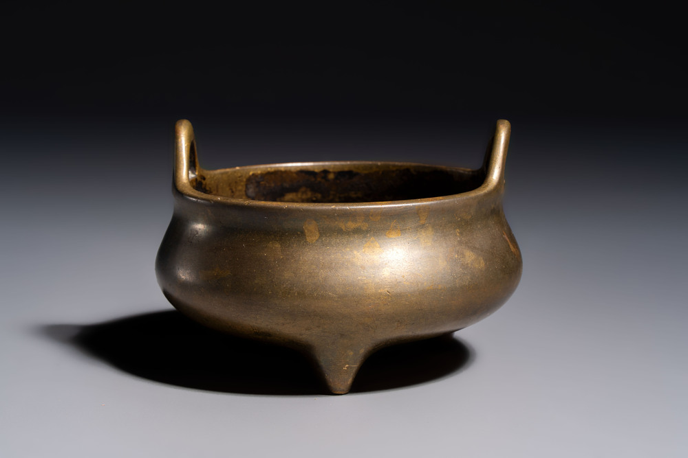 A Chinese bronze two-handled tripod censer, Xuande mark, 19th C.