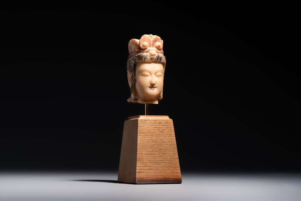 A rare Chinese polychrome carved white marble head of a Bodhisattva on a stand, Northern Qi