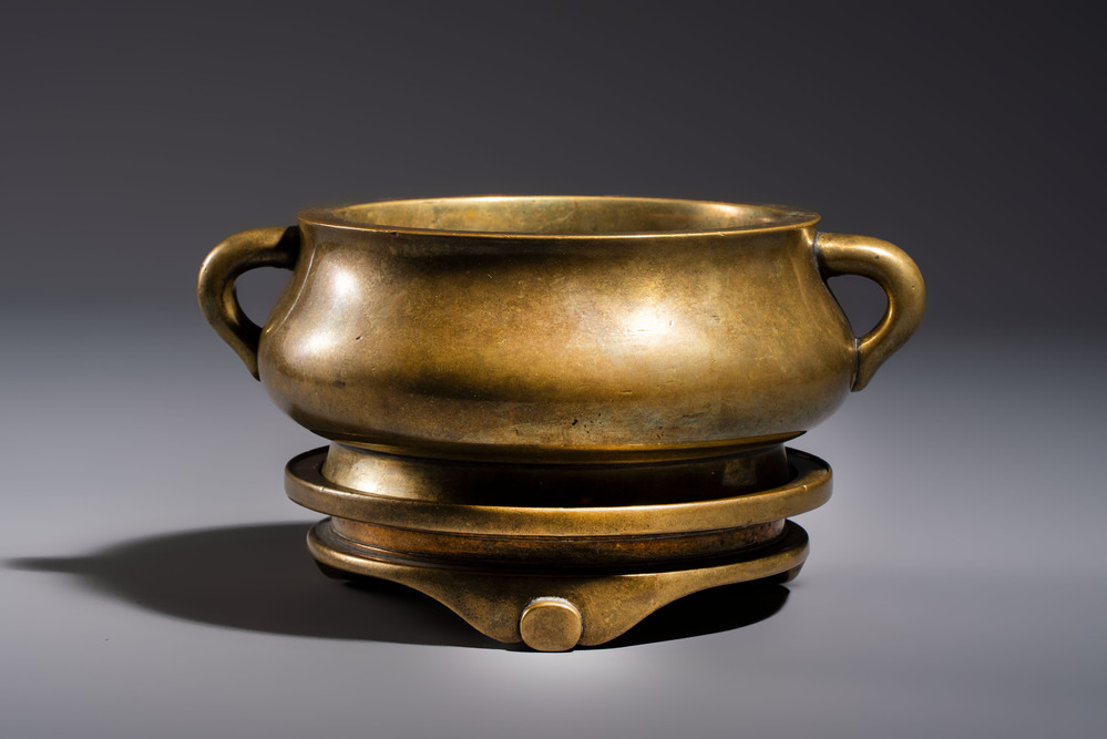 A fine Chinese bronze censer with loop handles and stand, Xuande mark, 18th C.