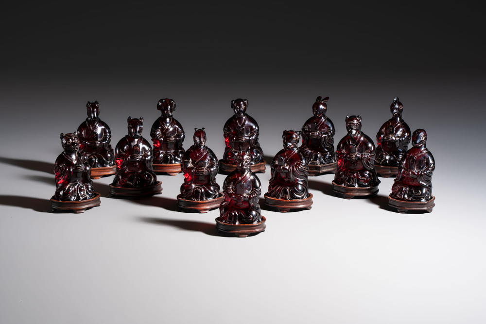 A rare complete set of 12 Chinese cherry amber 'Zodiac' figures on wooden stands, Qianlong mark, Republic