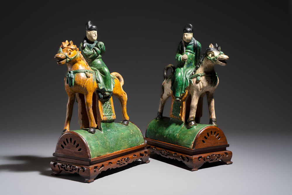A pair of Chinese sancai-glazed 'Horseriders' roof tiles on wooden stands, Ming