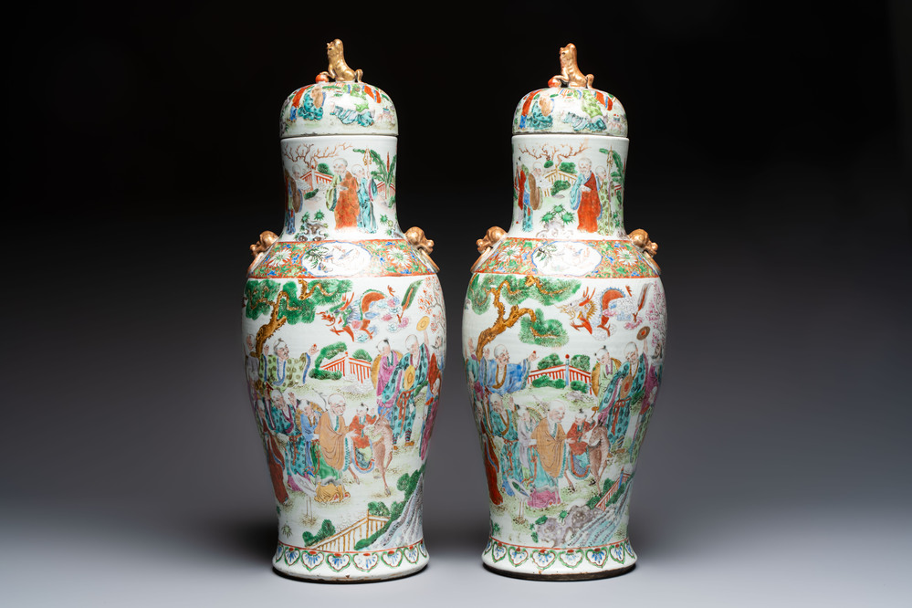 A pair of Chinese famille rose '18 Luohan' vases and covers, 19th C.