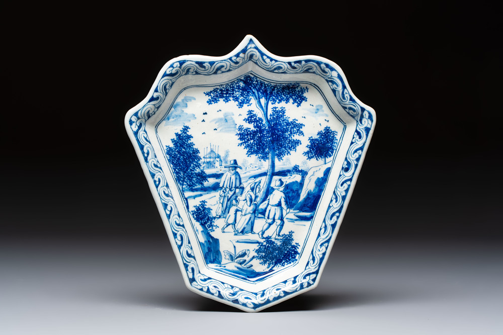 A fine blue and white Dutch Delft leaf-shaped dish with travellers in a landscape, early 18th C.