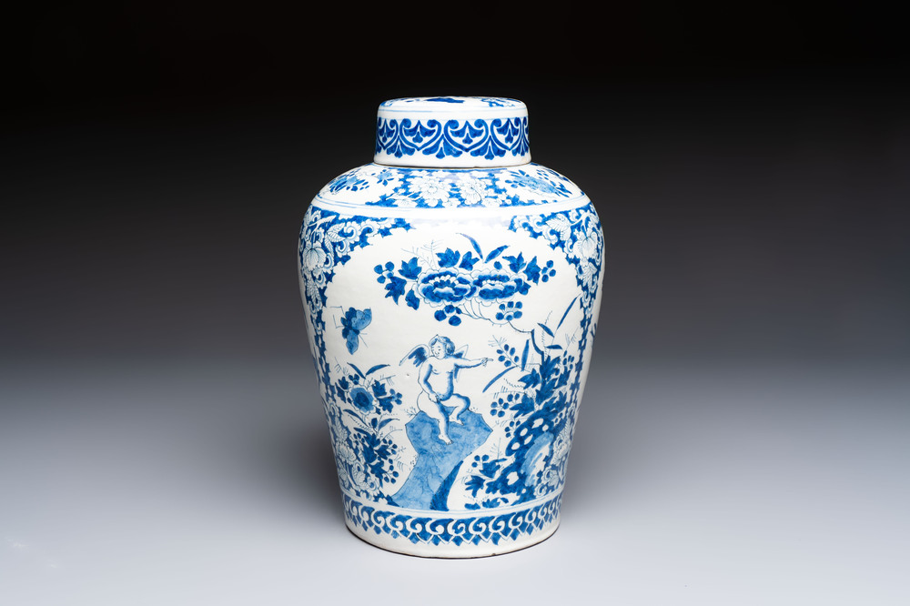 A refined blue and white Dutch Delft jar and cover with a putto on a rock, late 17th C.