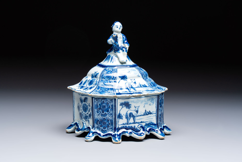 A blue and white Dutch Delft tobacco box and cover with a boy holding tobacco, 18th C.