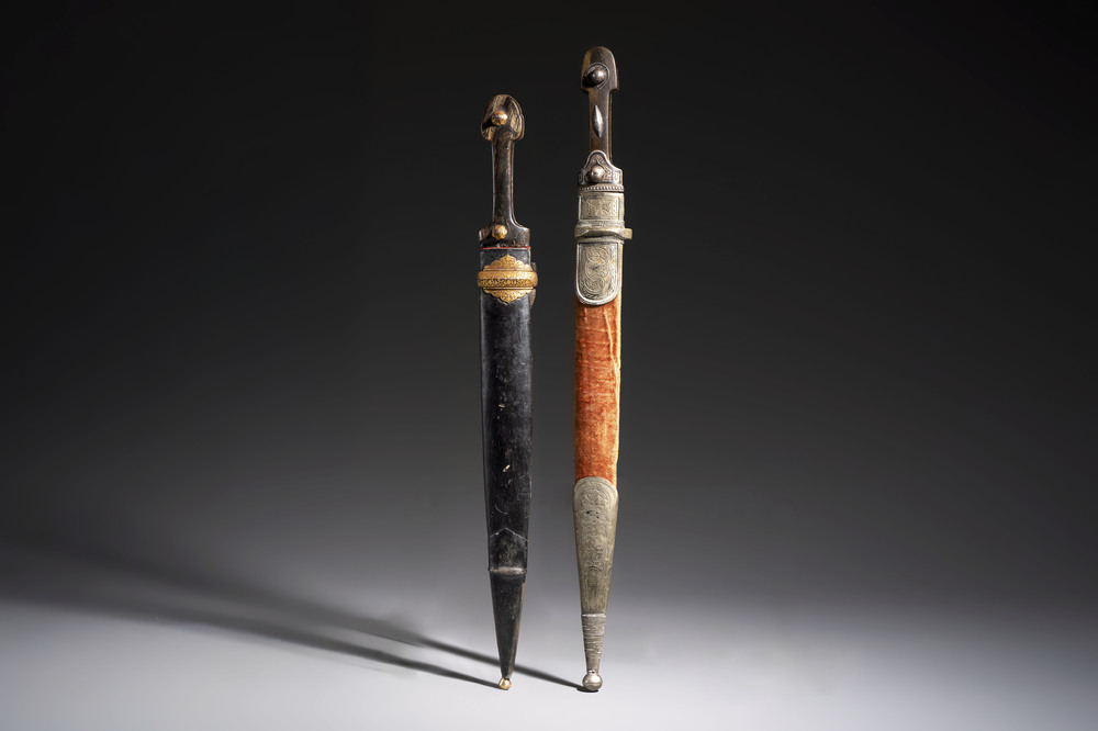 Two Caucasian Kindjal daggers with horn hilts, one with a gilt-iron-mounted leather scabbard and one with a metal-mounted velvet scabbard, 18/19th C