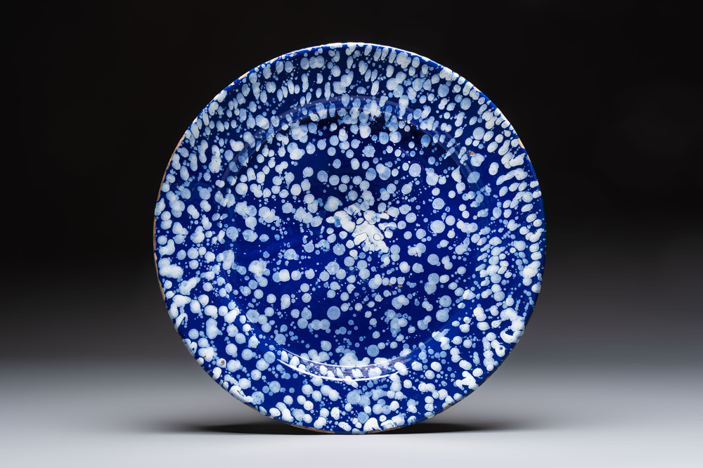 A rare large Nevers white-splashed blue-ground '&agrave; la bougie' dish, France, late 17th C.