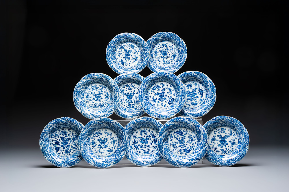 Eleven Chinese blue and white gadrooned 'Flowers and Peacocks' plates, Kangxi