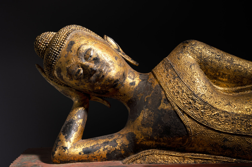 An exceptional and large Thai gilt-bronze figure of Buddha in Parinirvana, 18th C.