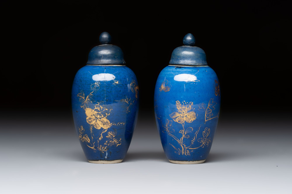 A pair of Chinese gilt-decorated powder-blue-ground miniature vases and wooden covers, 18th C.