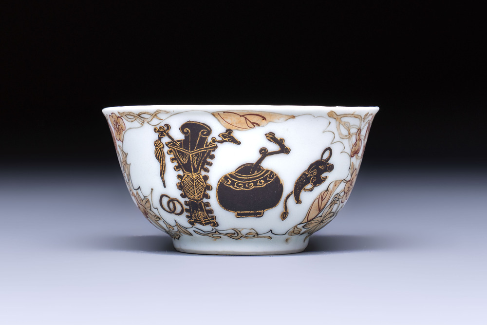 A Chinese gilt-decorated black-enamelled 'Antiquities' cup, Yongzheng/Qianlong