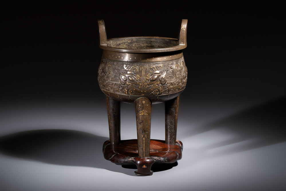 A rare Chinese gold- and silver-inlaid bronze 'Ding' censer with Taotie design on a hongmu stand, Shaosheng 紹聖 and Su Zhe 蘇轍 mark, Song or later