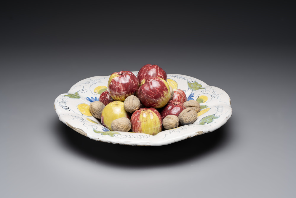 A rare polychrome Dutch Delft trompe-l'oeil dish with apples and walnuts, 17th C.
