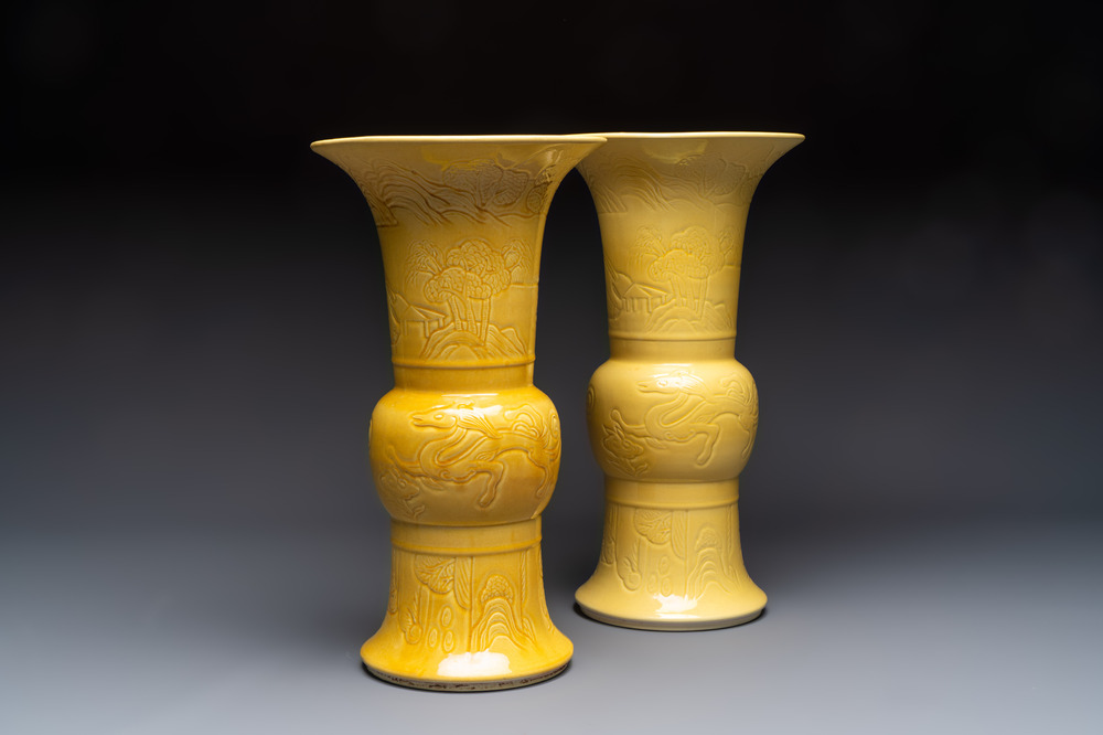 A pair of Chinese yellow-glazed 'Gu' vases with incised chilongs and landscapes, Chenghua mark, 20th C.