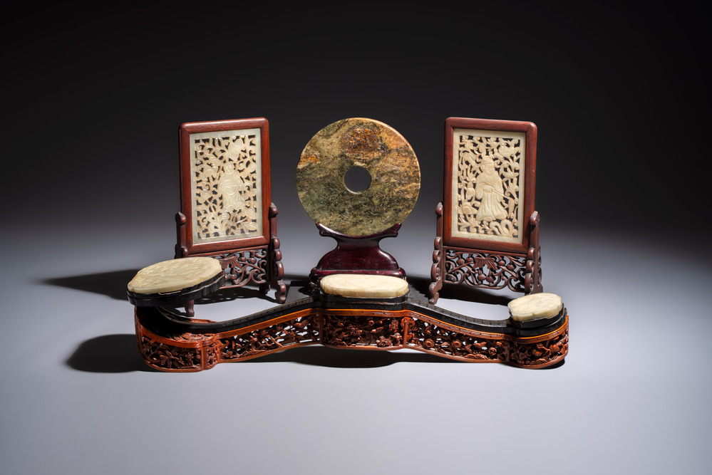 A pair of Chinese jade-inset wooden table screens, a jade-inset wooden ruyi with its original stand and a jade 'bi' disc on a wooden stand, 19/20th C.