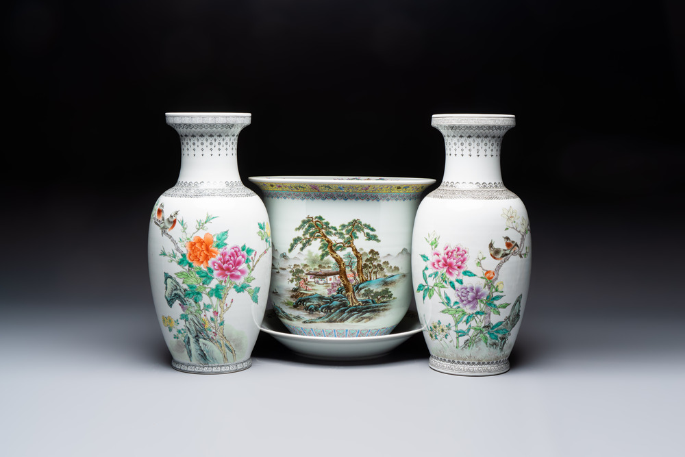 A Chinese famille rose 'Mountainous Landscape' jardiniere with a stand and a pair of vases with floral design, Qianlong marks, 20th C.