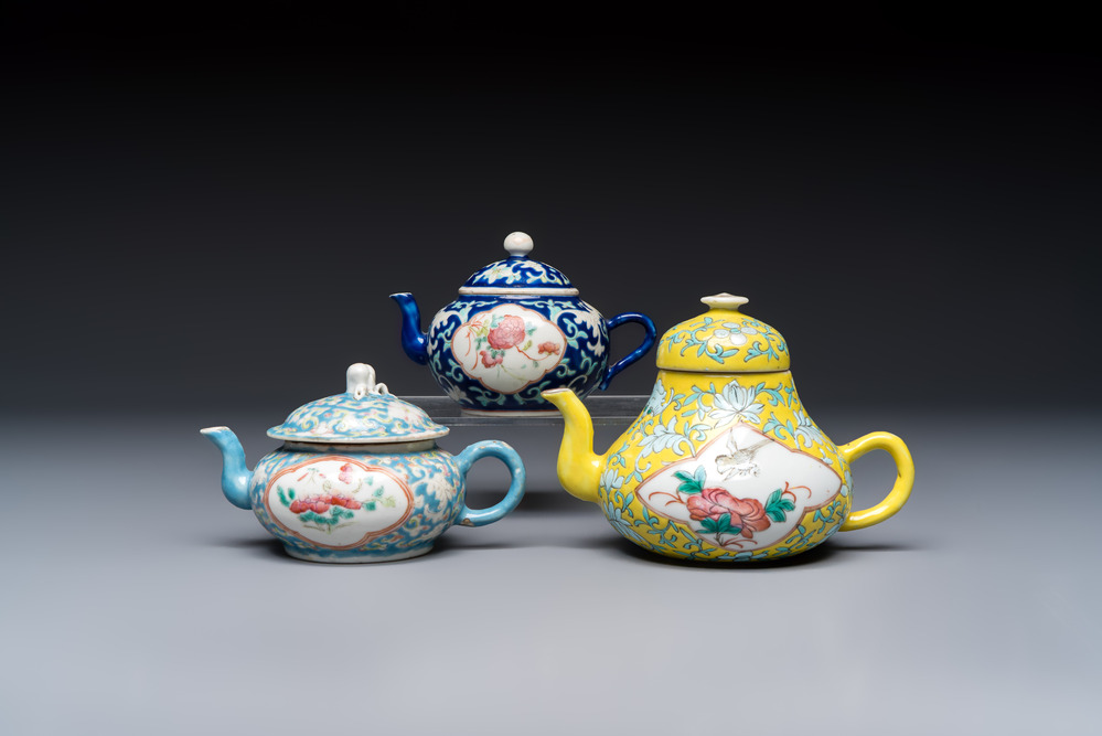 Three Chinese famille rose blue- and yellow-ground teapots and covers for the Straits or Peranakan market, Tongzhi marks, 19th C.